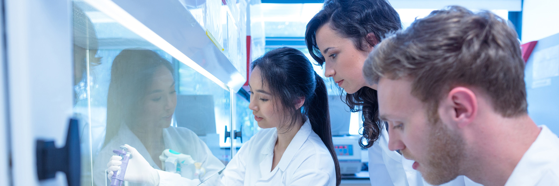 three pharmaceutical scientists observing a test